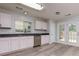 Bright kitchen with stainless steel appliances and gray countertops and double doors to back yard at 301 Silver Spring St, Dallas, GA 30157