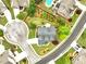 Aerial view of a home with a well-manicured lawn, a pool, driveway, and surrounded by lush greenery at 3174 Piney Woods Cir, Buford, GA 30519