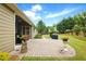 Charming backyard patio with stone walkway, potted plants, a grill, and lush green lawn at 3174 Piney Woods Cir, Buford, GA 30519