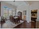 Bright dining area with large windows, hardwood floors, and elegant light fixture for comfortable and stylish meals at 3174 Piney Woods Cir, Buford, GA 30519