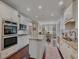 Gourmet kitchen with stainless steel appliances, granite countertops, and custom cabinetry for a chef-inspired culinary experience at 3174 Piney Woods Cir, Buford, GA 30519