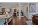 Open-concept living area with hardwood floors connecting the entryway, living room, and dining space at 3174 Piney Woods Cir, Buford, GA 30519