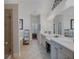A luxurious bathroom with a long vanity, double sinks, a soaking tub, and a stand-up shower is featured at 3174 Piney Woods Cir, Buford, GA 30519