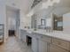A luxurious bathroom featuring a long vanity, double sinks, a soaking tub, and a stand-up shower at 3174 Piney Woods Cir, Buford, GA 30519