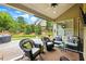 Inviting outdoor patio with comfortable seating, ceiling fan, and a view of the landscaped backyard at 3174 Piney Woods Cir, Buford, GA 30519