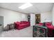 Cozy finished basement with comfortable seating and a well-lit ceiling at 3885 Weeping Willow Ln, Loganville, GA 30052