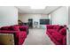 Spacious finished basement with comfortable seating and various electronics at 3885 Weeping Willow Ln, Loganville, GA 30052