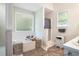 Bright bathroom showcasing a soaking tub and a separate shower with natural light from two windows at 3885 Weeping Willow Ln, Loganville, GA 30052
