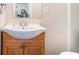 Bathroom vanity featuring a wooden base and a modern sink with a mirror at 3885 Weeping Willow Ln, Loganville, GA 30052