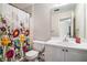 Bathroom featuring a floral shower curtain, white sink, and vanity with a mirror at 3885 Weeping Willow Ln, Loganville, GA 30052