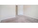 Empty bedroom featuring neutral walls, trim and carpet with two visible electrical outlets at 3885 Weeping Willow Ln, Loganville, GA 30052