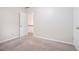 Bright bedroom featuring neutral walls, carpet, natural light, and a door leading to the hallway at 3885 Weeping Willow Ln, Loganville, GA 30052