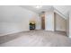 Large bonus room featuring neutral walls, carpet, and access to a secondary room through a white door at 3885 Weeping Willow Ln, Loganville, GA 30052