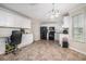 Spacious kitchen equipped with white cabinetry, black appliances, tile flooring, and ample counter space at 3885 Weeping Willow Ln, Loganville, GA 30052