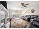Inviting living room features a large leather sectional sofa, fireplace, ceiling fan, and stylish area rug at 3885 Weeping Willow Ln, Loganville, GA 30052
