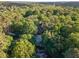 Aerial view of the property surrounded by lush greenery, showcasing the serene and private setting at 8260 Overview Ct, Roswell, GA 30076