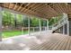 Wood deck overlooks the green backyard with wood support posts and stairway access to the yard at 8260 Overview Ct, Roswell, GA 30076