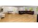 This finished basement includes a leather couch, a table tennis setup, and a neutral vinyl floor at 8260 Overview Ct, Roswell, GA 30076