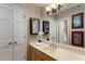 This bathroom boasts a mirror with lighting, linen closet, framed art, and a vanity with a countertop at 8260 Overview Ct, Roswell, GA 30076
