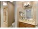 This bathroom features a single sink vanity with a mirror, and a shower with glass doors at 8260 Overview Ct, Roswell, GA 30076