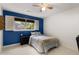A serene bedroom with a navy accent wall, a window with shutters, and neutral bedding for a calming space at 8260 Overview Ct, Roswell, GA 30076