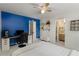 This bedroom features a comfy bed, navy accent wall, desk, shelves, and ensuite bathroom for added privacy at 8260 Overview Ct, Roswell, GA 30076