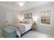 Bright bedroom featuring a queen bed, neutral decor, and ample natural light from a large window at 8260 Overview Ct, Roswell, GA 30076
