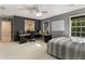 This bedroom features a ceiling fan and a gray accent wall complete with a desk, computer, and fun artwork at 8260 Overview Ct, Roswell, GA 30076