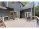Large wood deck with French doors, gas grill and wrought iron furniture set on home's upper level at 8260 Overview Ct, Roswell, GA 30076