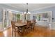 Dining room with hardwood floors, large bay window, and traditional light fixture at 8260 Overview Ct, Roswell, GA 30076