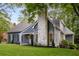 Home featuring blue siding and an elegant stone chimney at 8260 Overview Ct, Roswell, GA 30076