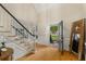 Bright foyer with hardwood floors, staircase, and front door with decorative glass at 8260 Overview Ct, Roswell, GA 30076