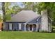 Charming home featuring a stone chimney, blue siding, and a well-manicured lawn at 8260 Overview Ct, Roswell, GA 30076