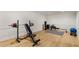 Brightly lit home gym with weights, exercise bench, rowing machine and heavy bag at 8260 Overview Ct, Roswell, GA 30076