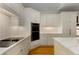Elegant kitchen boasts white cabinetry, marble countertops, subway tile backsplash, and high-end stainless steel appliances at 8260 Overview Ct, Roswell, GA 30076