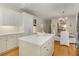 Updated kitchen island with marble countertop in the kitchen with white cabinets and stainless steel appliances at 8260 Overview Ct, Roswell, GA 30076