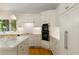 Modern kitchen featuring sleek white cabinets, stainless steel appliances, and wood floors at 8260 Overview Ct, Roswell, GA 30076