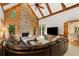 Bright living room featuring a fireplace, exposed beams, and open doorway to the dining room at 8260 Overview Ct, Roswell, GA 30076