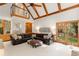 Living room with cathedral ceilings, exposed beams, large windows, and access to a loft at 8260 Overview Ct, Roswell, GA 30076