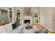 Cozy living room with fireplace, hardwood floors, and large windows at 8260 Overview Ct, Roswell, GA 30076