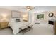 Spacious main bedroom featuring a cozy fireplace, seating area, neutral decor, and abundant natural light from large windows at 8260 Overview Ct, Roswell, GA 30076