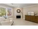 Relaxing sitting area with fireplace, neutral decor, large window, and hardwood dresser at 8260 Overview Ct, Roswell, GA 30076