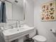 Powder room featuring pedestal sink, toilet, wall art, mirror and towel bar at 120 Biscayne Nw Dr # C13, Atlanta, GA 30309