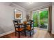 Cozy dining area featuring hard wood floors, wooden furniture, a sliding glass door with a view of the outside at 120 Biscayne Nw Dr # C13, Atlanta, GA 30309