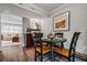 Inviting dining area showcasing an outdoor view, a round table for four, hard wood floors and soft lighting at 120 Biscayne Nw Dr # C13, Atlanta, GA 30309