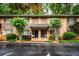 Charming brick townhome featuring a cozy entrance, stone accents and landscaped greenery, perfect for comfortable living at 120 Biscayne Nw Dr # C13, Atlanta, GA 30309