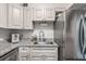 Modern kitchen featuring granite countertops, subway tile backsplash, stainless steel refrigerator and bright white cabinetry at 120 Biscayne Nw Dr # C13, Atlanta, GA 30309