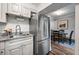 Well-lit kitchen shows stainless steel refrigerator next to dining area with dark wood table and chairs at 120 Biscayne Nw Dr # C13, Atlanta, GA 30309