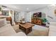 Relaxing living room featuring hard wood floors, a plush couch, a decorative tv stand, and abundant light at 120 Biscayne Nw Dr # C13, Atlanta, GA 30309