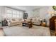 Cozy living room showcasing hardwood floors, plush seating, and abundant light from large windows for a welcoming atmosphere at 120 Biscayne Nw Dr # C13, Atlanta, GA 30309